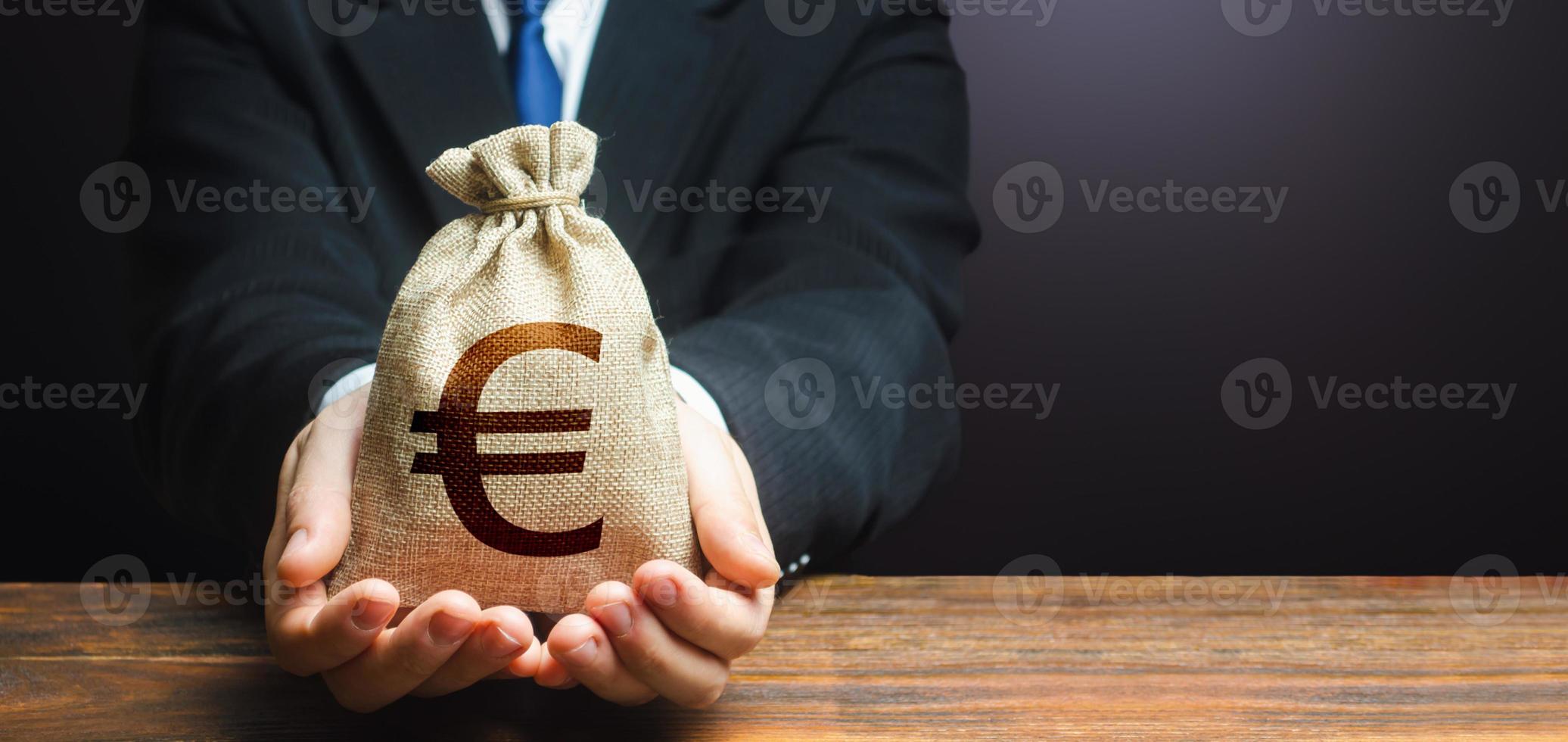Businessman holds out euro money bag. Mortgage, loan approval