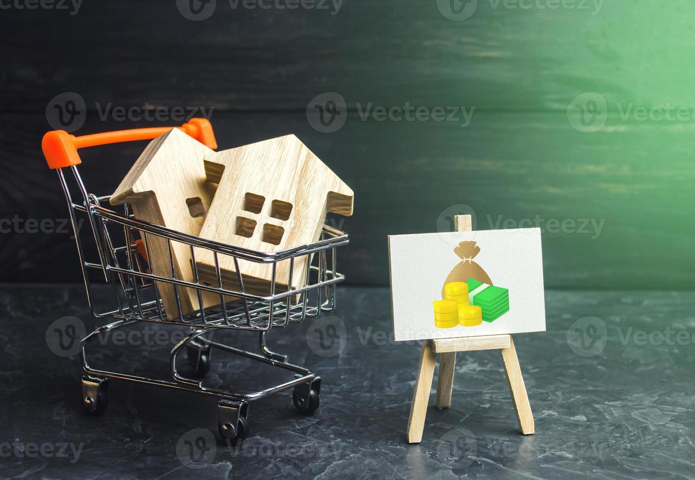 Houses in a shopping cart at a fair price. Home purchase, invest in real estate. Property appraisal. Bank approval for issuing a mortgage loan. Favorable terms and conditions, low interest rate. photo