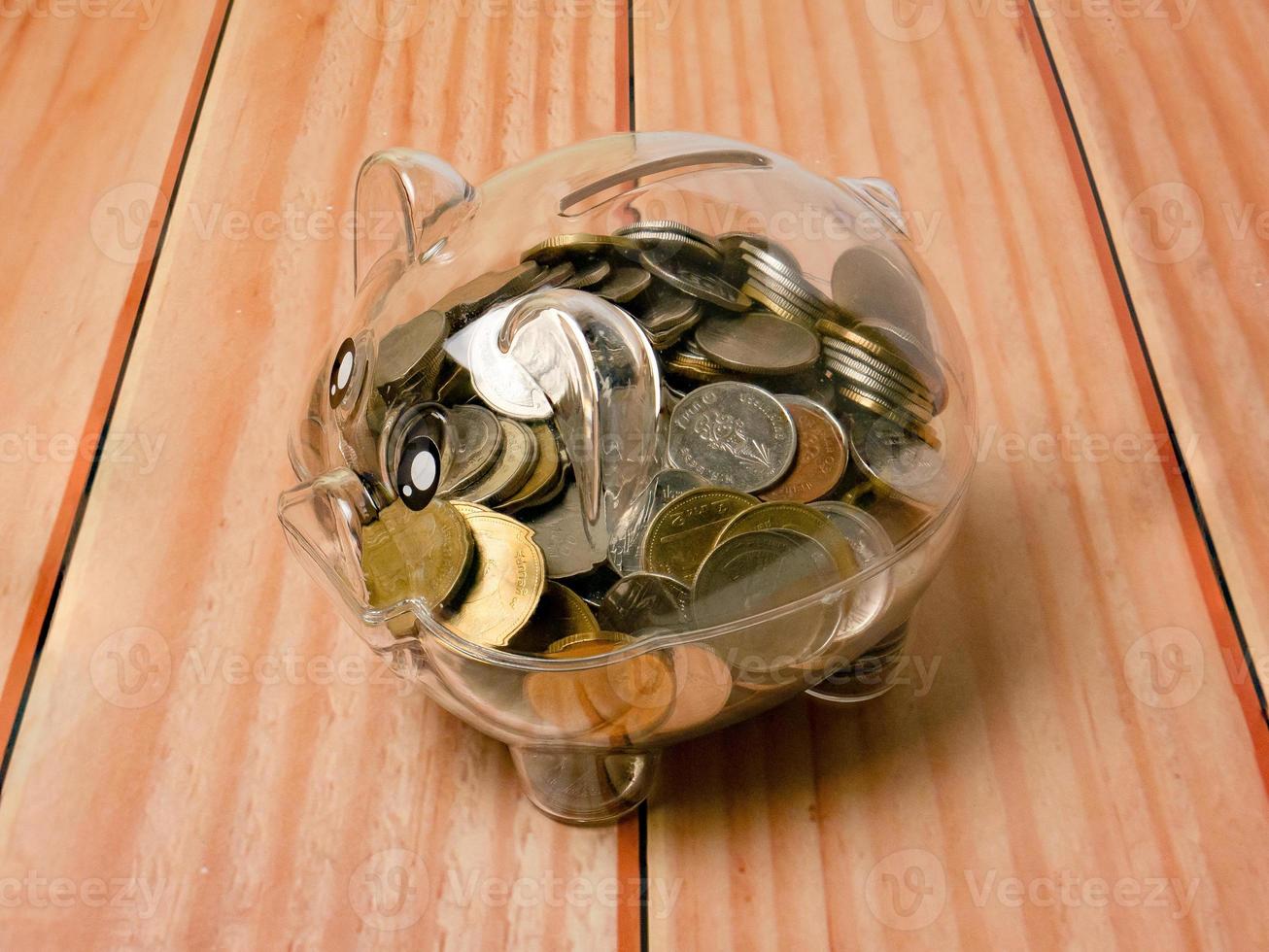 The piggy bank on wood table for earn or saving concept photo