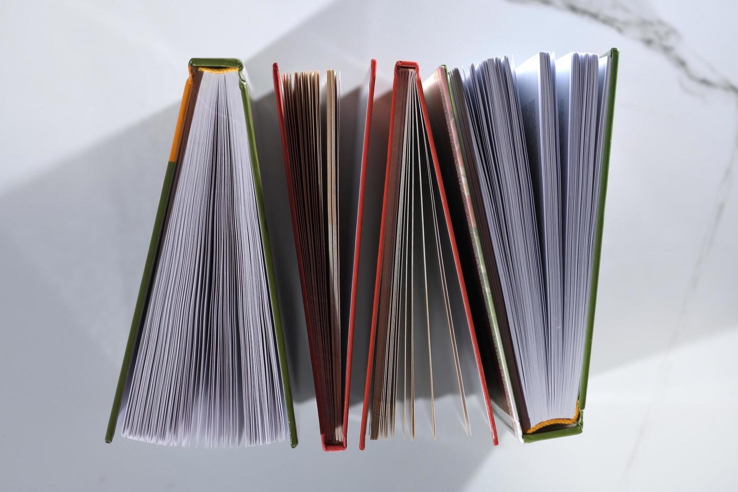 Top view of four books on white background photo