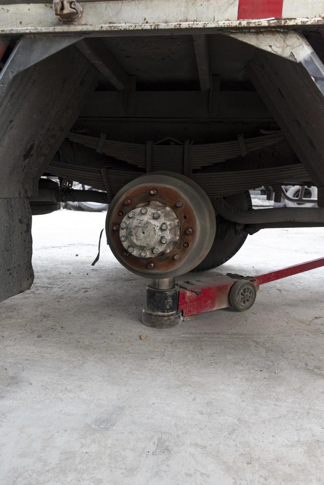 Truck change wheels using a lifting jack. photo