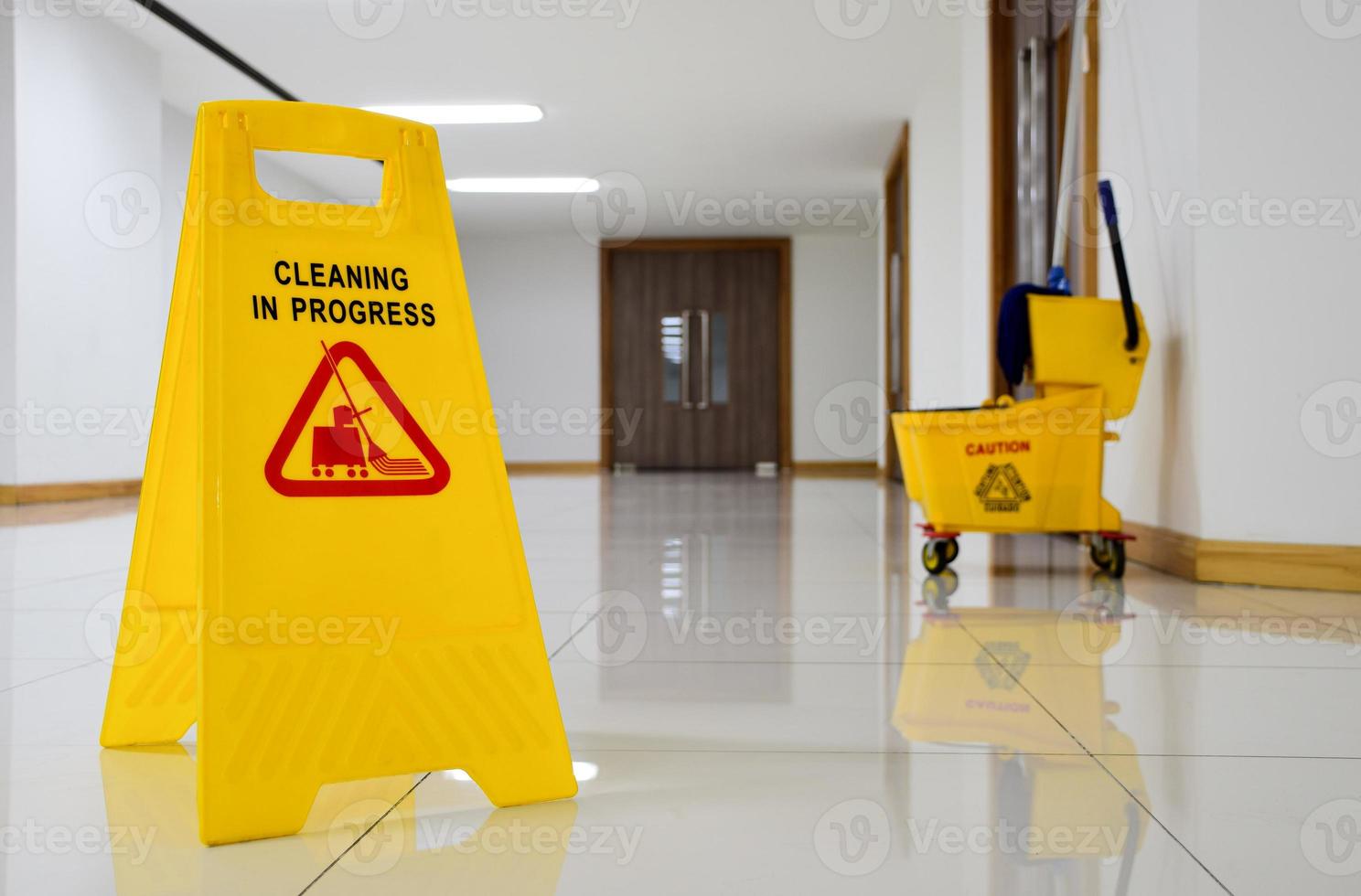 Close up yellow warning sign with message Cleaning in progress photo