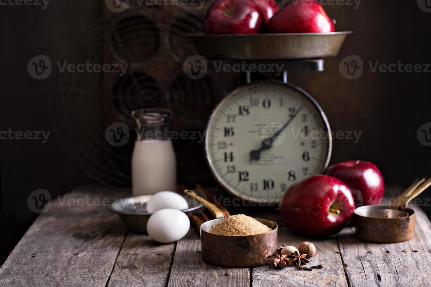 Baking with apples ingredients on rustic table photo