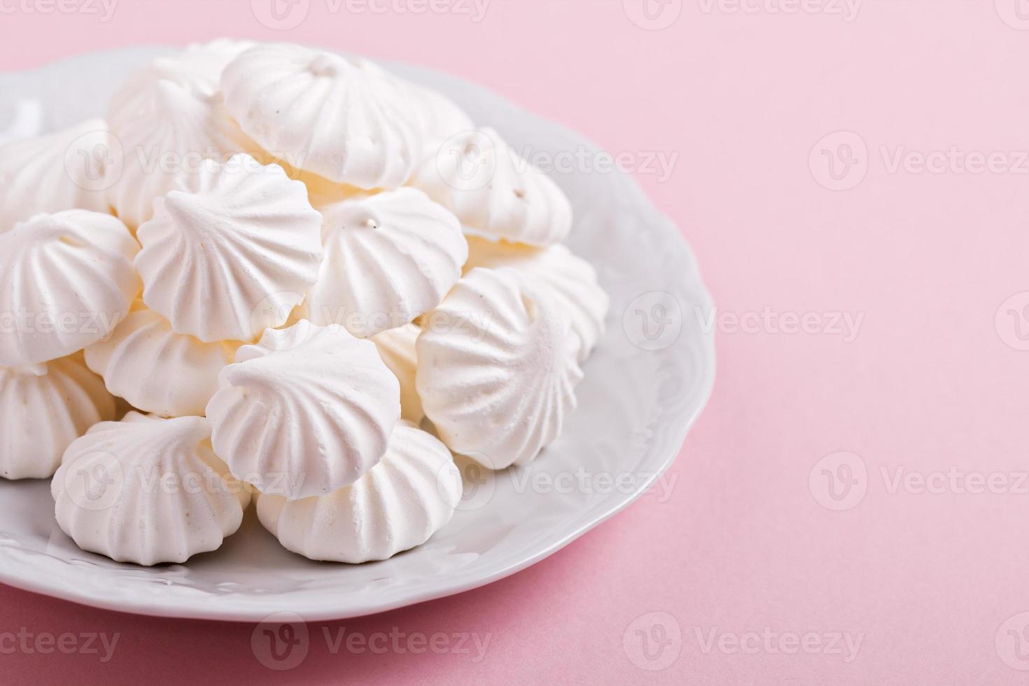 Meringue kisses cookies on a white plate photo