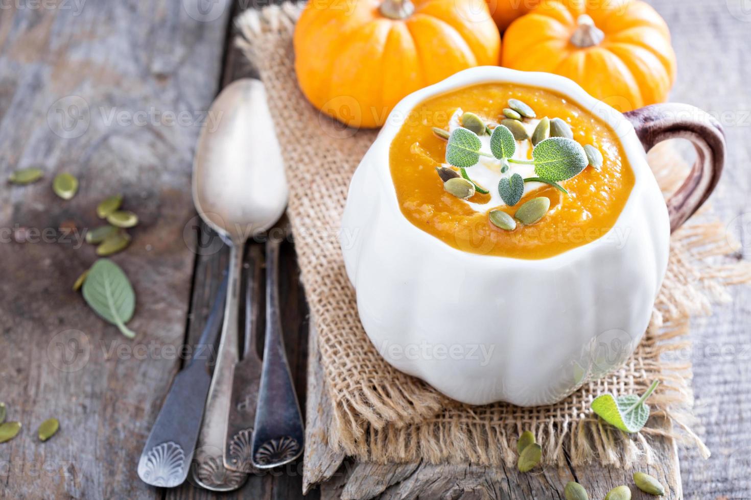 Pumpkin soup with cream, herbs and seeds photo