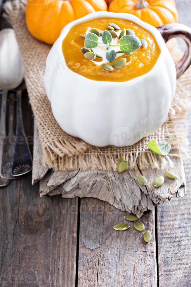 Pumpkin soup with cream, herbs and seeds photo