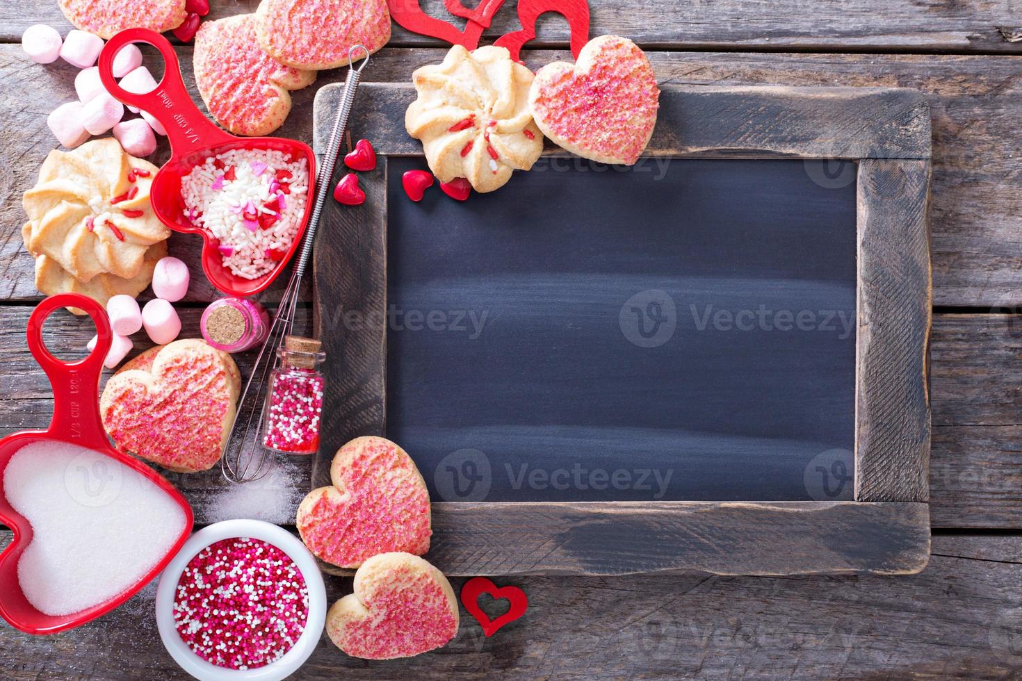 Valentines day cookies around a chalkboard photo