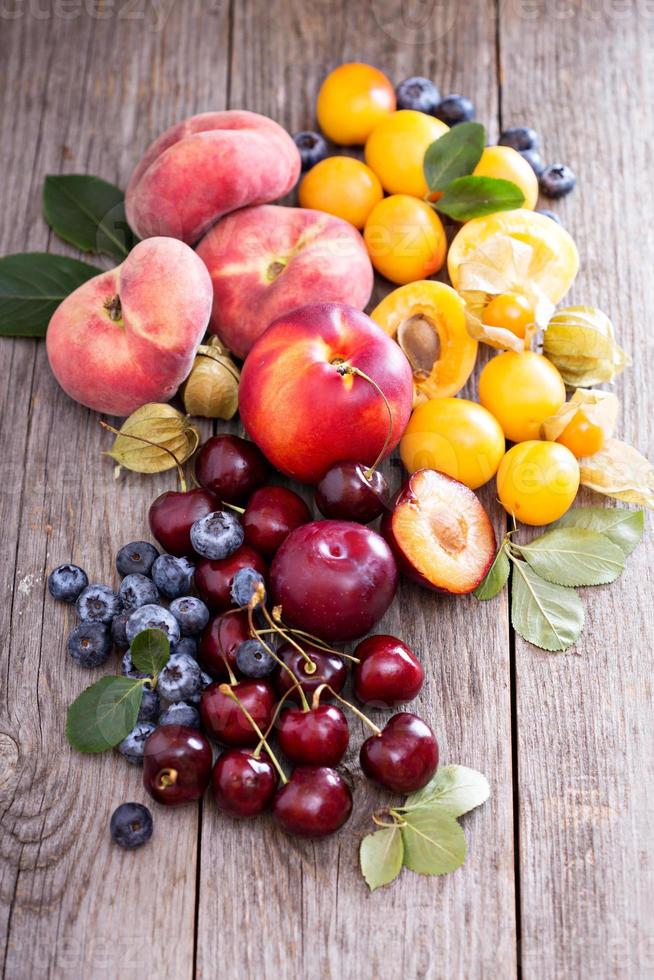 Summer fruits on wooden table photo