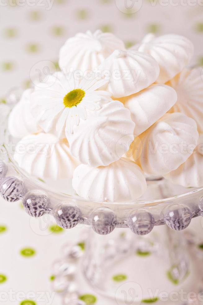 Meringue kisses cookies on a cake stand photo