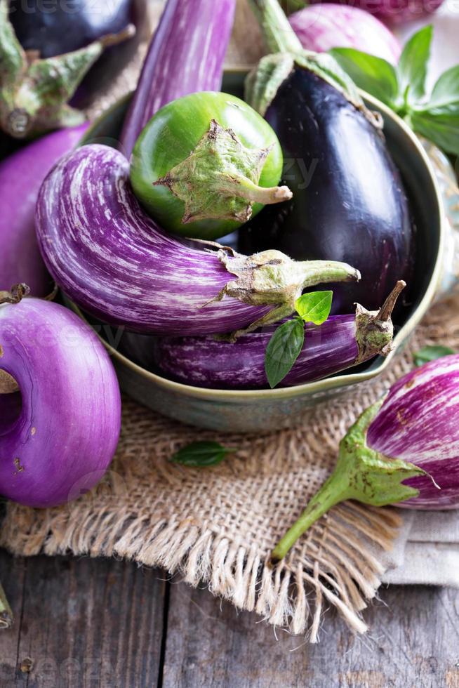Eggplants of different variety on the table photo
