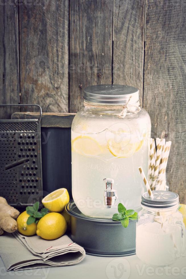 Ginger homemade lemonade in a beverage dispencer photo