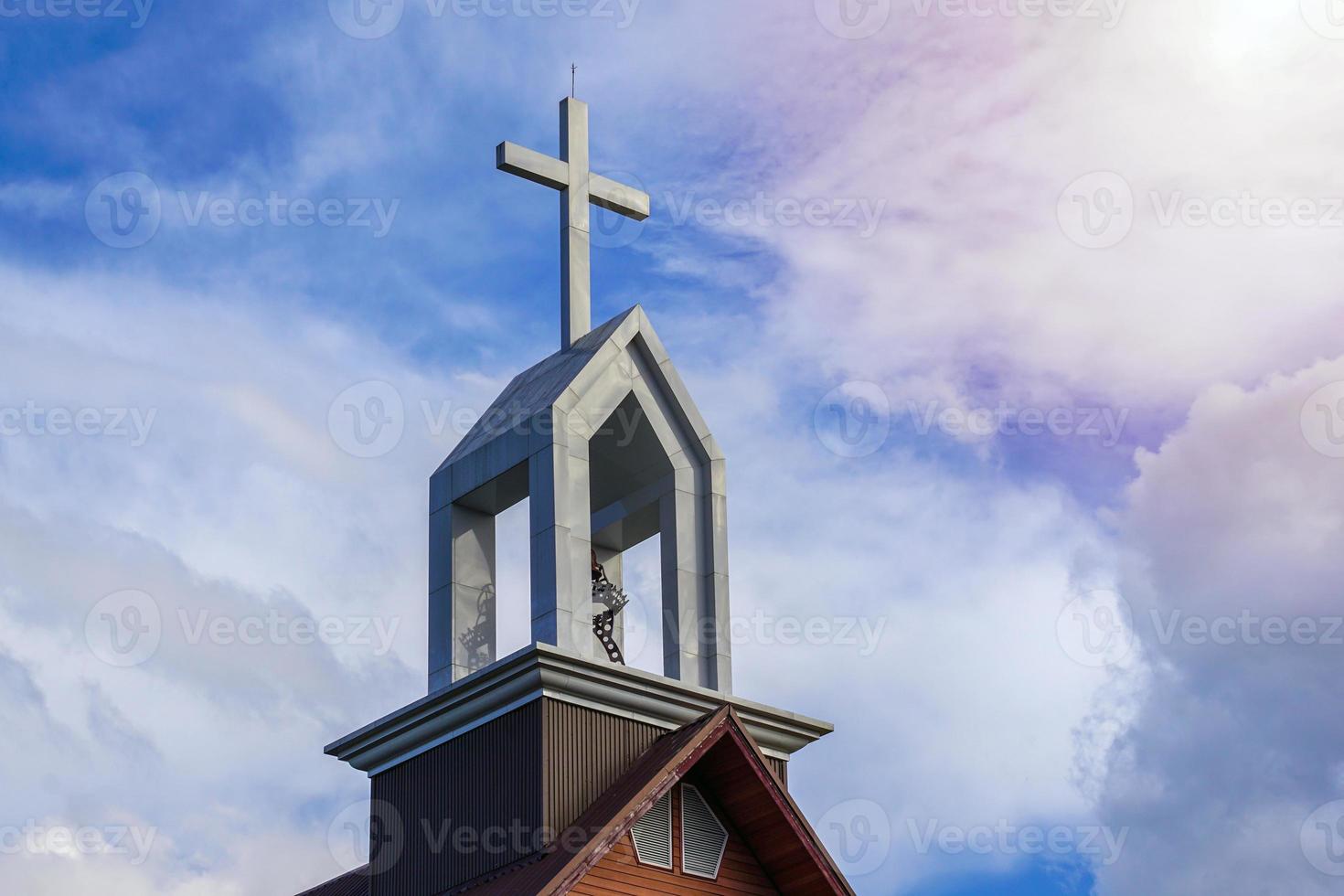 White cross on the roof of the Asian Basilica of Christ against the background of the daytime sky. Soft and selective focus. photo