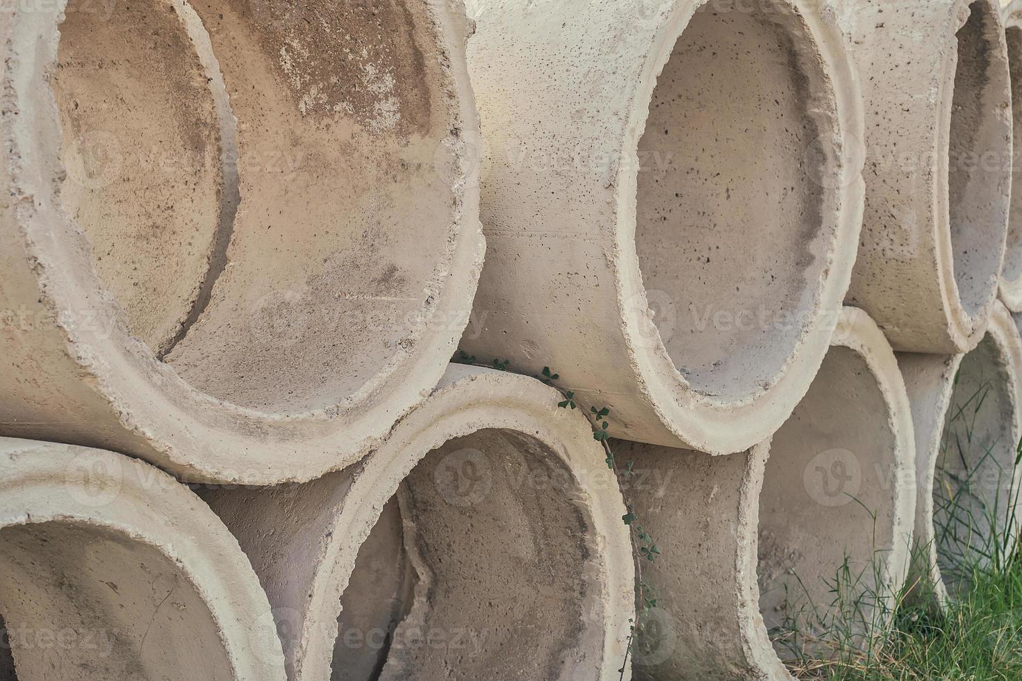 Concrete circles for a well and construction. Goods in stock, construction and repair of houses, delivery and sale of building materials. photo