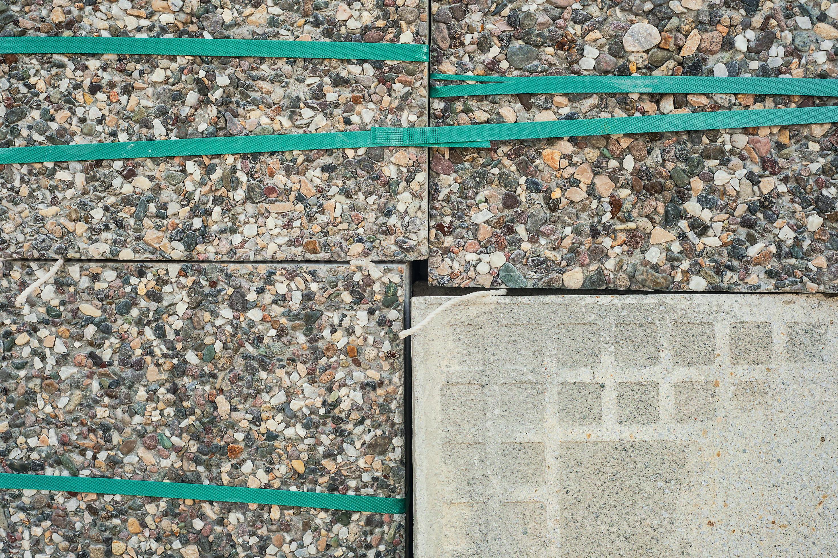 Paving slabs packed with tape on pallets. Goods in stock, construction and repair, delivery and