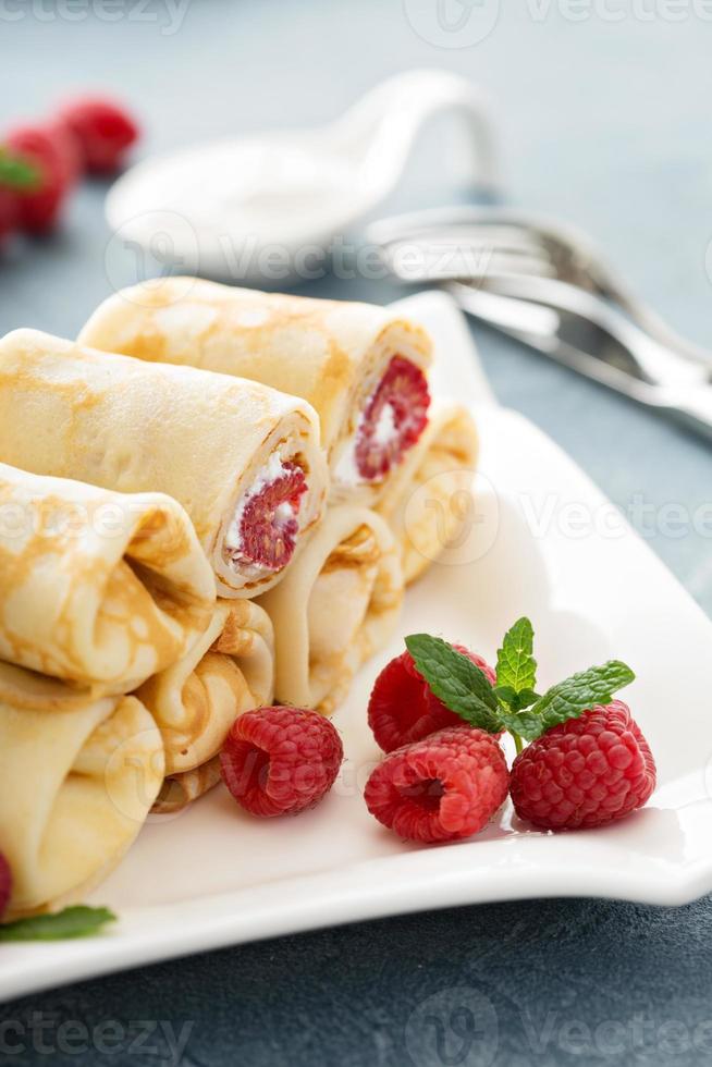 Crepes filled with cottage cheese and raspberry photo