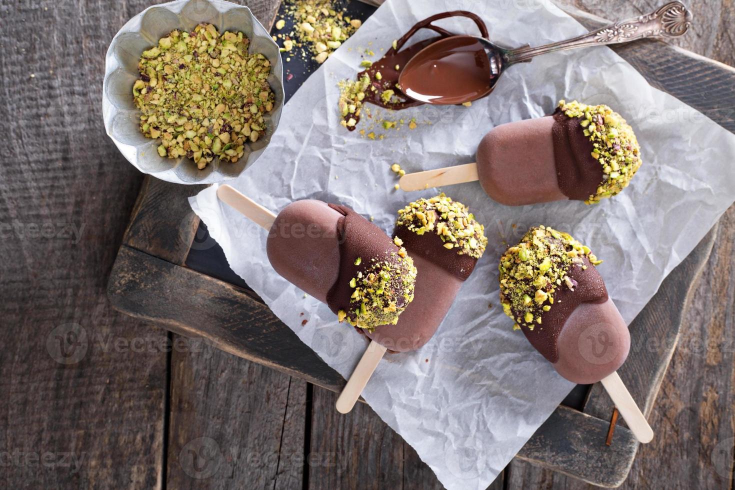 Chocolate pops with pistachios photo