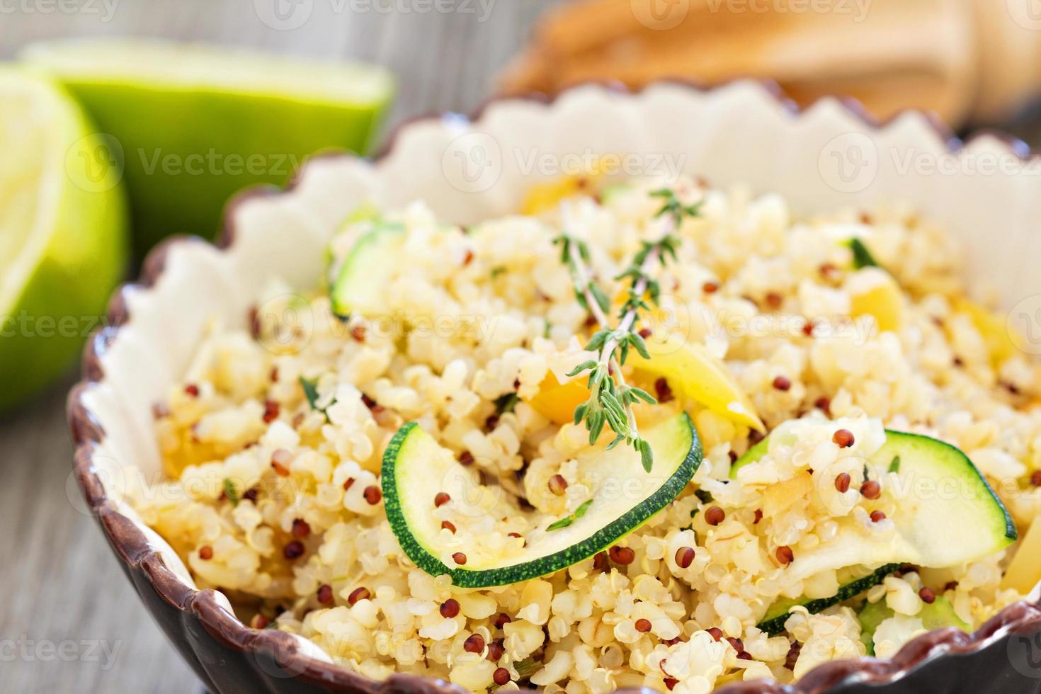 Warm quinoa salad with vegetables in a bowl photo