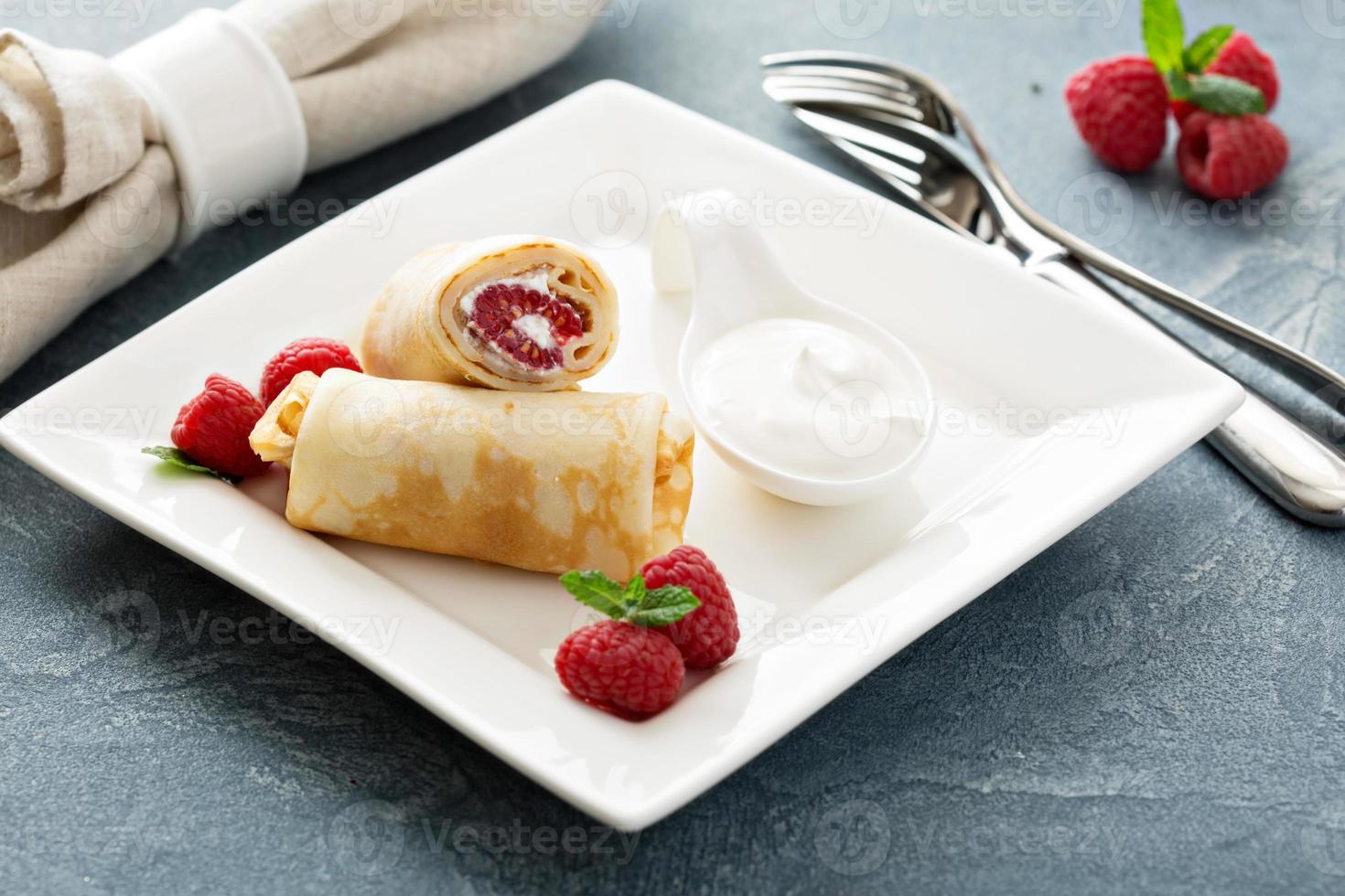 Crepes filled with cottage cheese and raspberry photo
