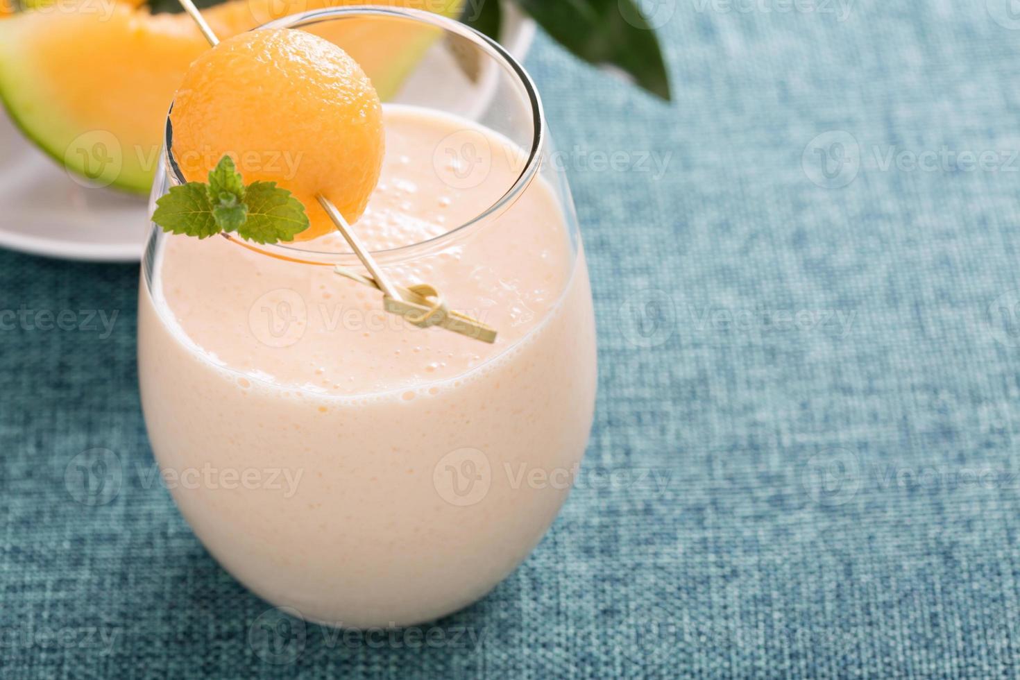 Melon smoothie on a table photo