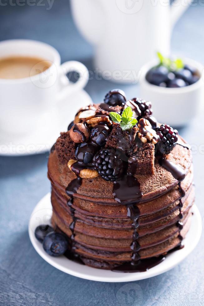 Stack of chocolate pancakes with toppings photo