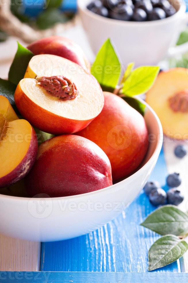 Fresh nectarines in a bowl 15700781 Stock Photo at Vecteezy
