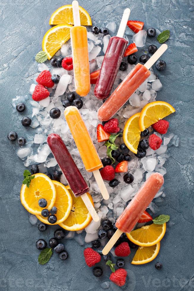 Variety of ice popsicles with fruits photo