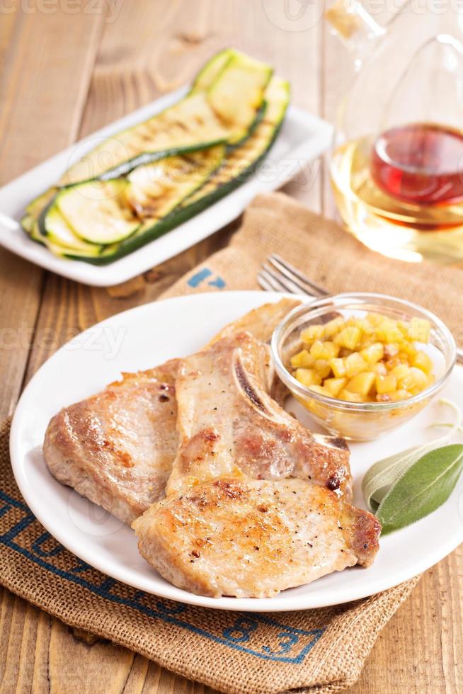 Pork cutlets on a bone with apple chutney photo