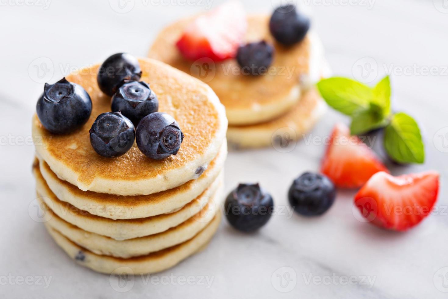 Stack of small pancakes with berries photo
