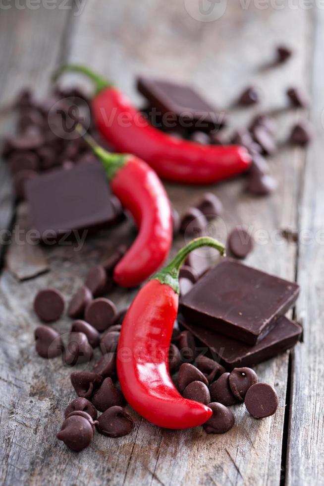 Dark chocolate pieces and chips with hot chilli pepper photo