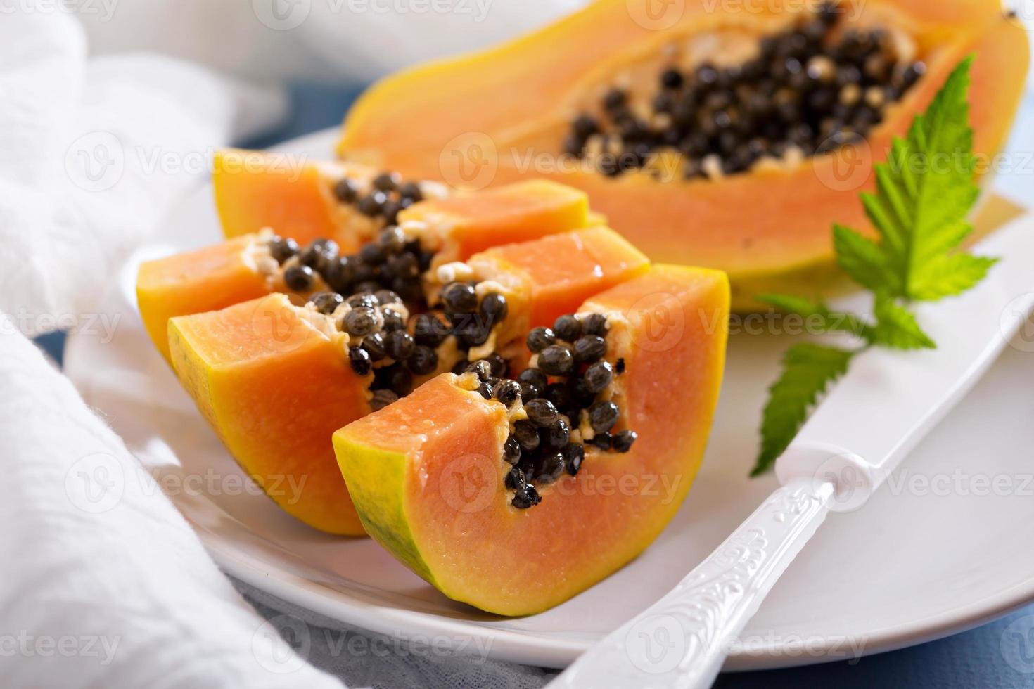 Cut papaya on a blue table photo