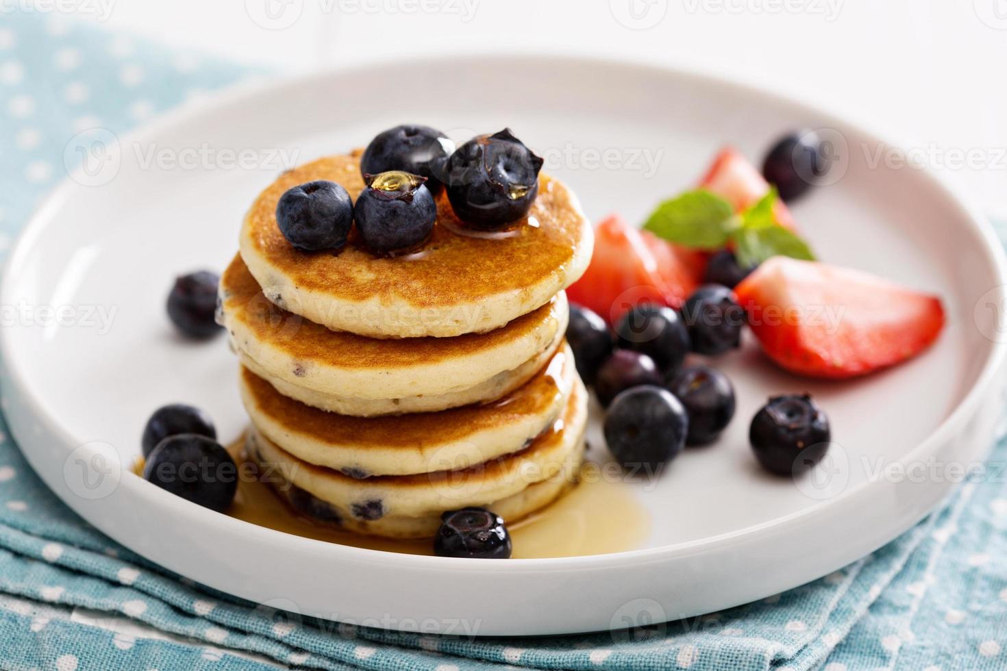 Stack of small pancakes with berries photo