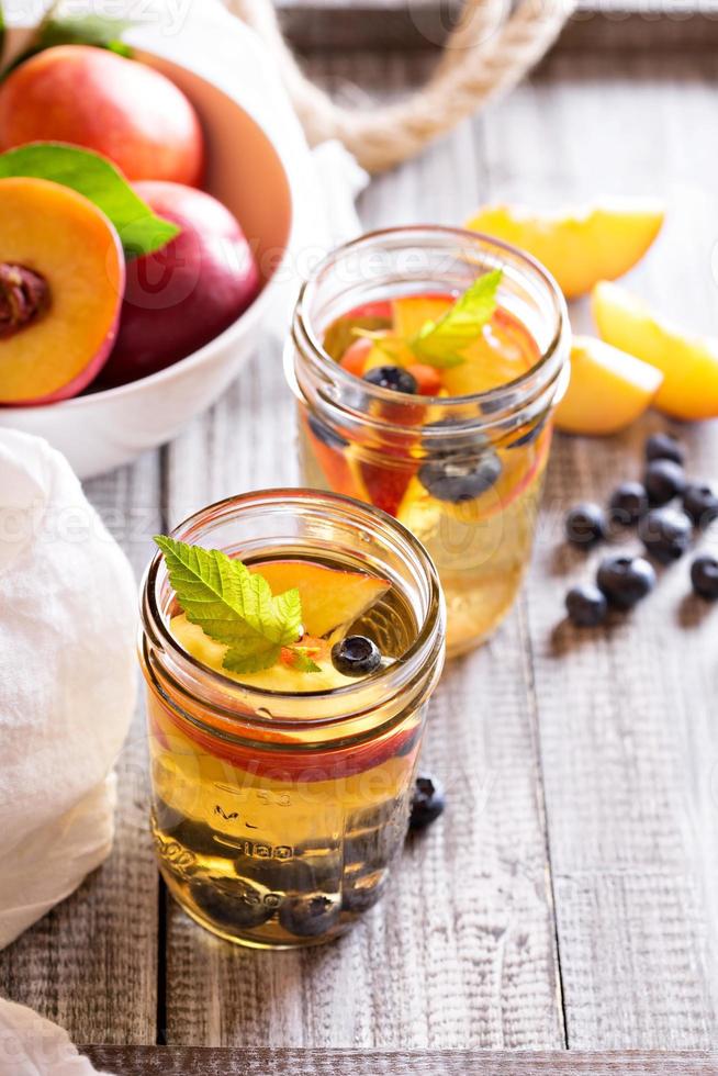 Green iced tea with nectarines and blueberries photo