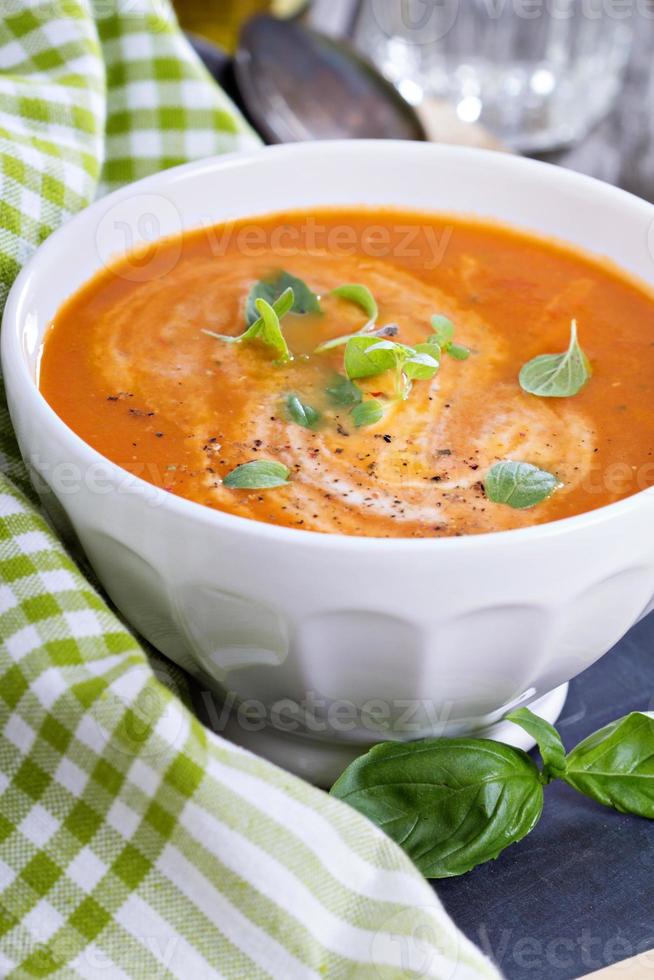 Tomato soup in white bowl photo
