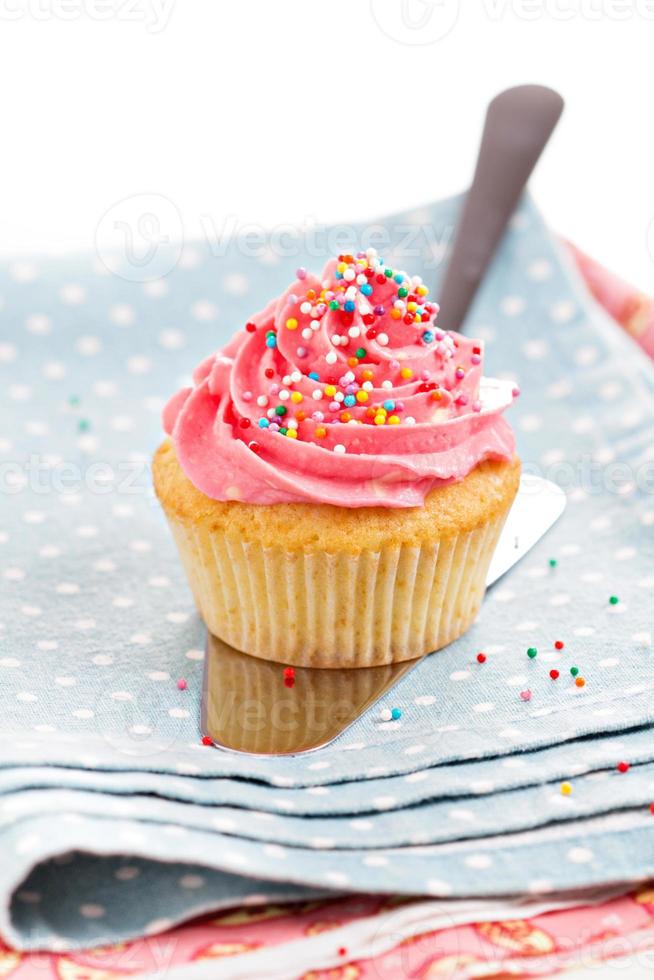 Cupcake with frosting and sprinkles photo