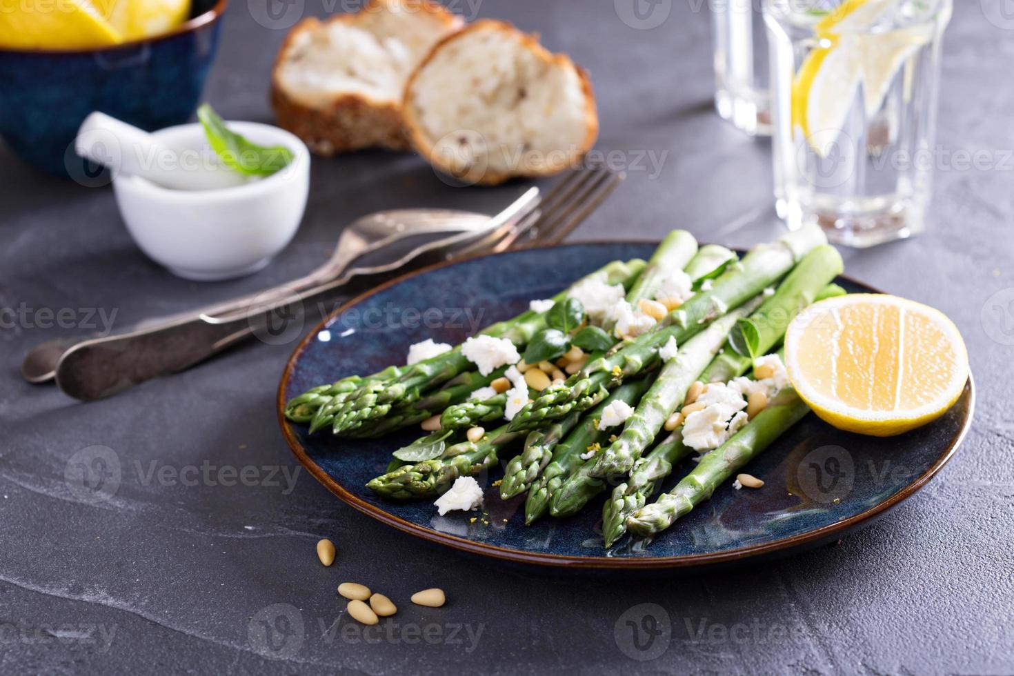 Warm salad with asparagus, feta cheese and lemon photo