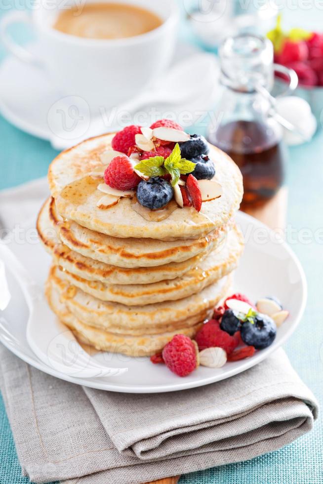 Fluffy oatmeal pancakes stack with fresh berries photo