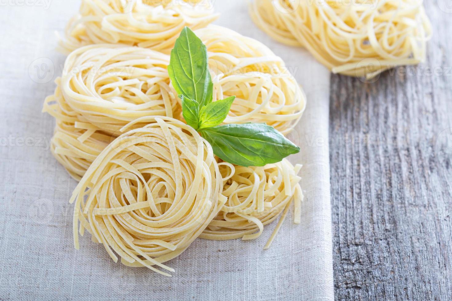 Dry pasta with fresh basil photo