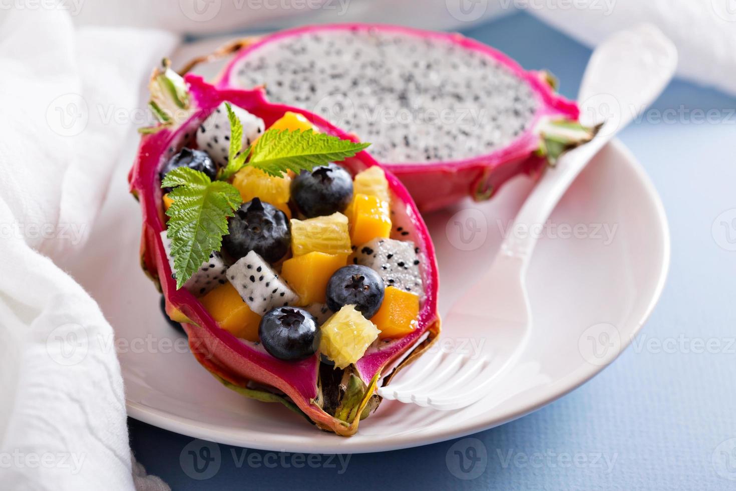 Tropical exotic salad inside a dragon fruit photo