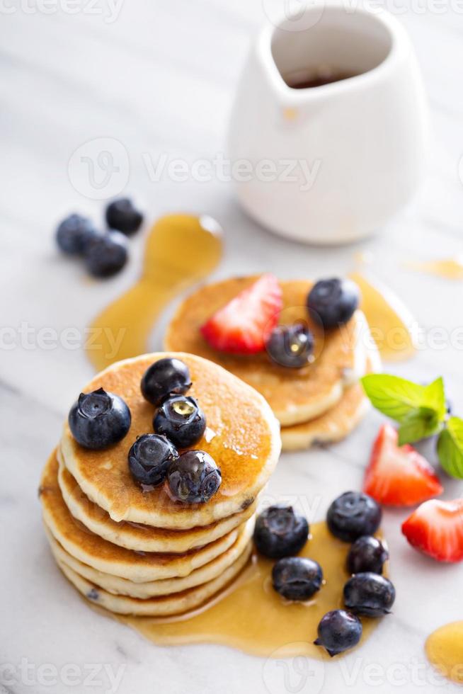 Stack of small pancakes with berries photo