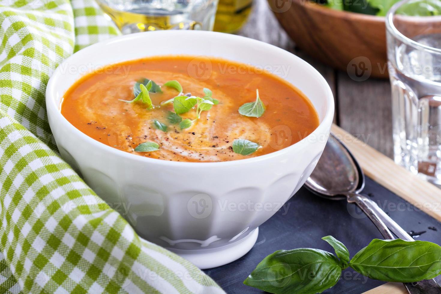 Tomato soup in white bowl photo