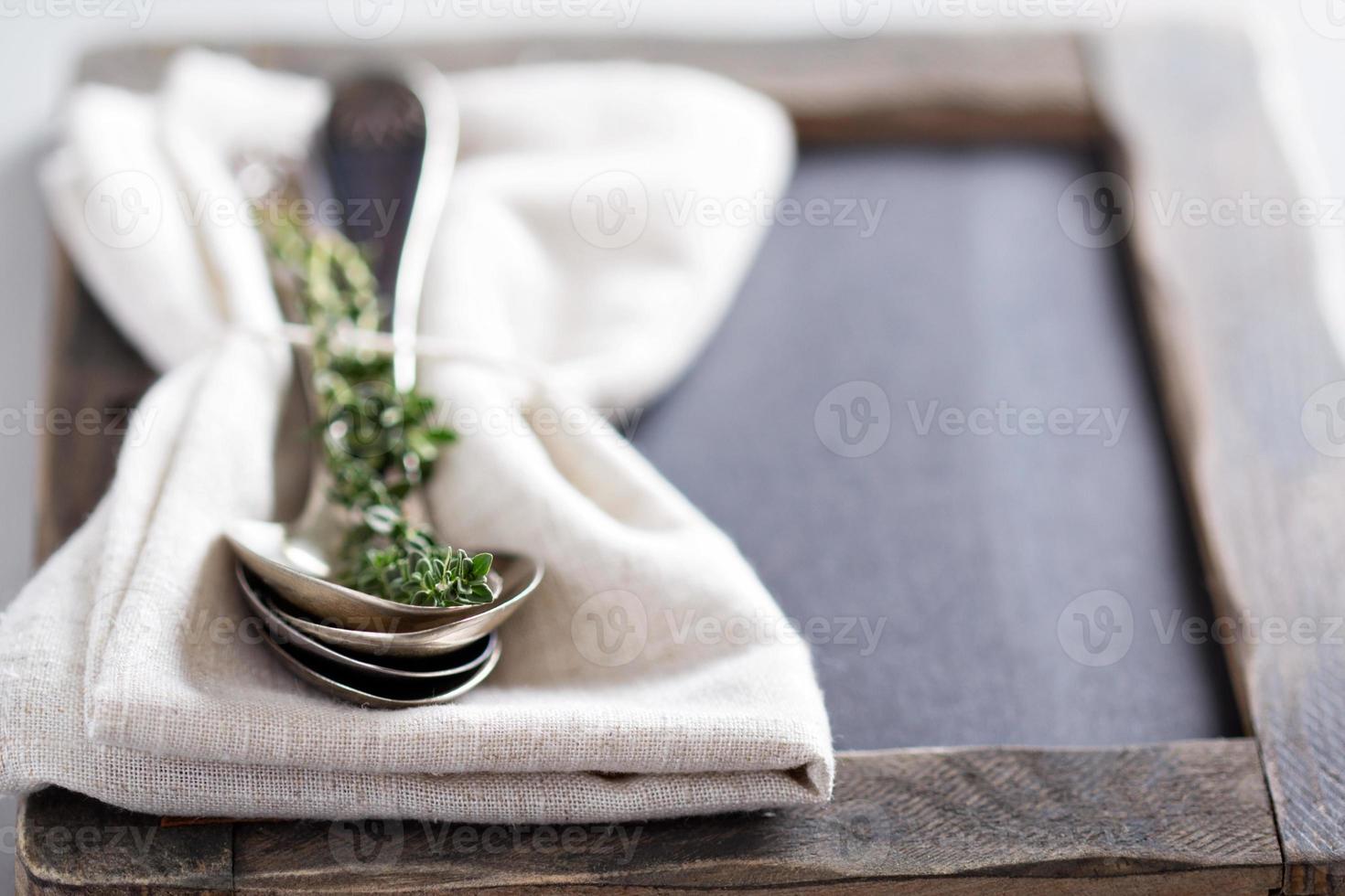 Tablespoons with a napkin and thyme photo