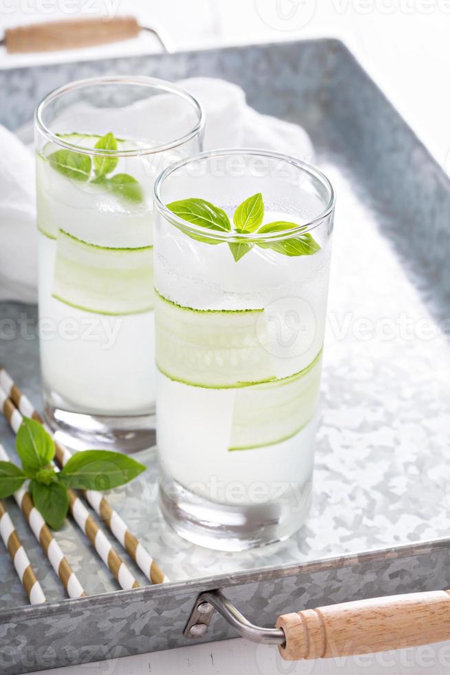 Basil cucumber sparkling drink in tall glasses photo