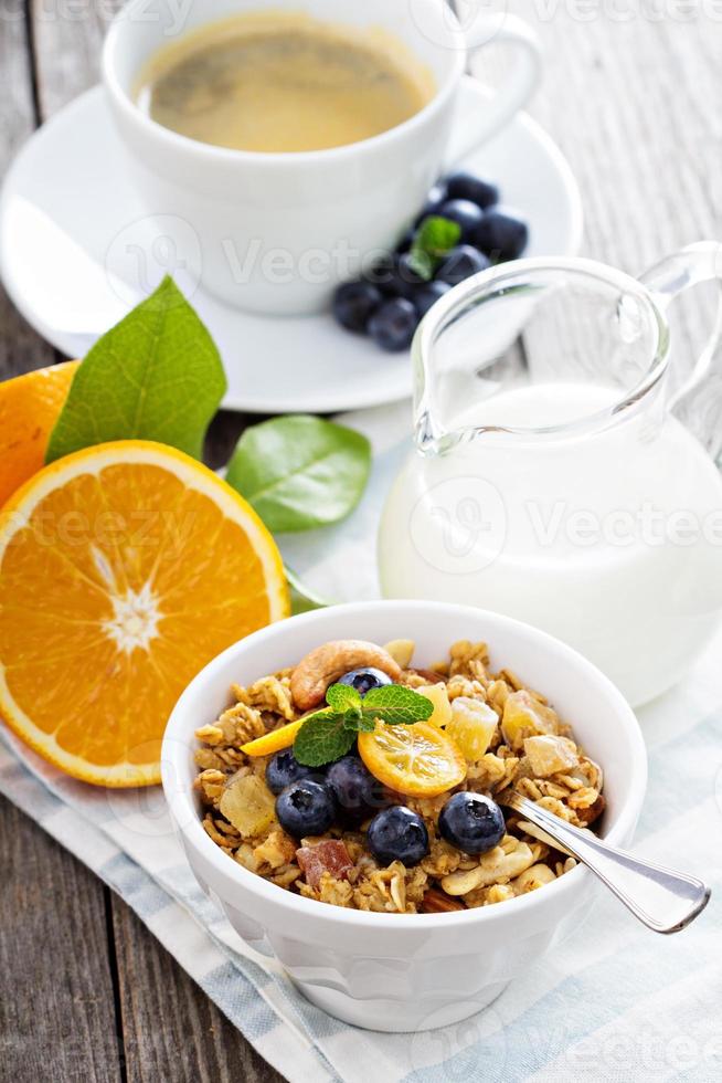 Breakfast set on the table with granola photo