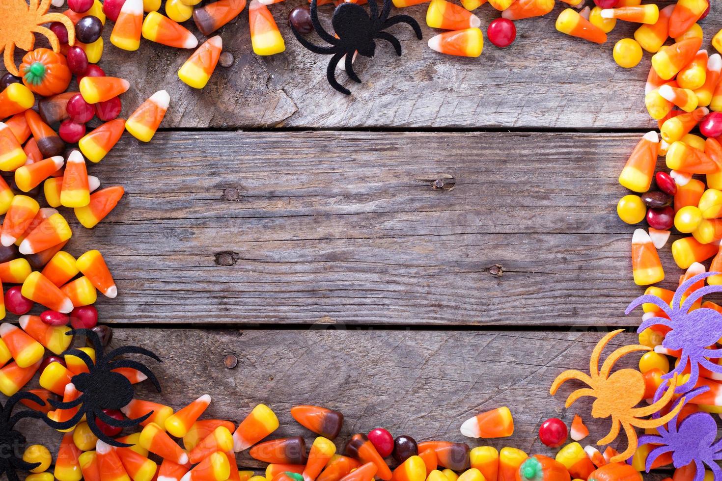 Halloween candy frame around rustic board photo