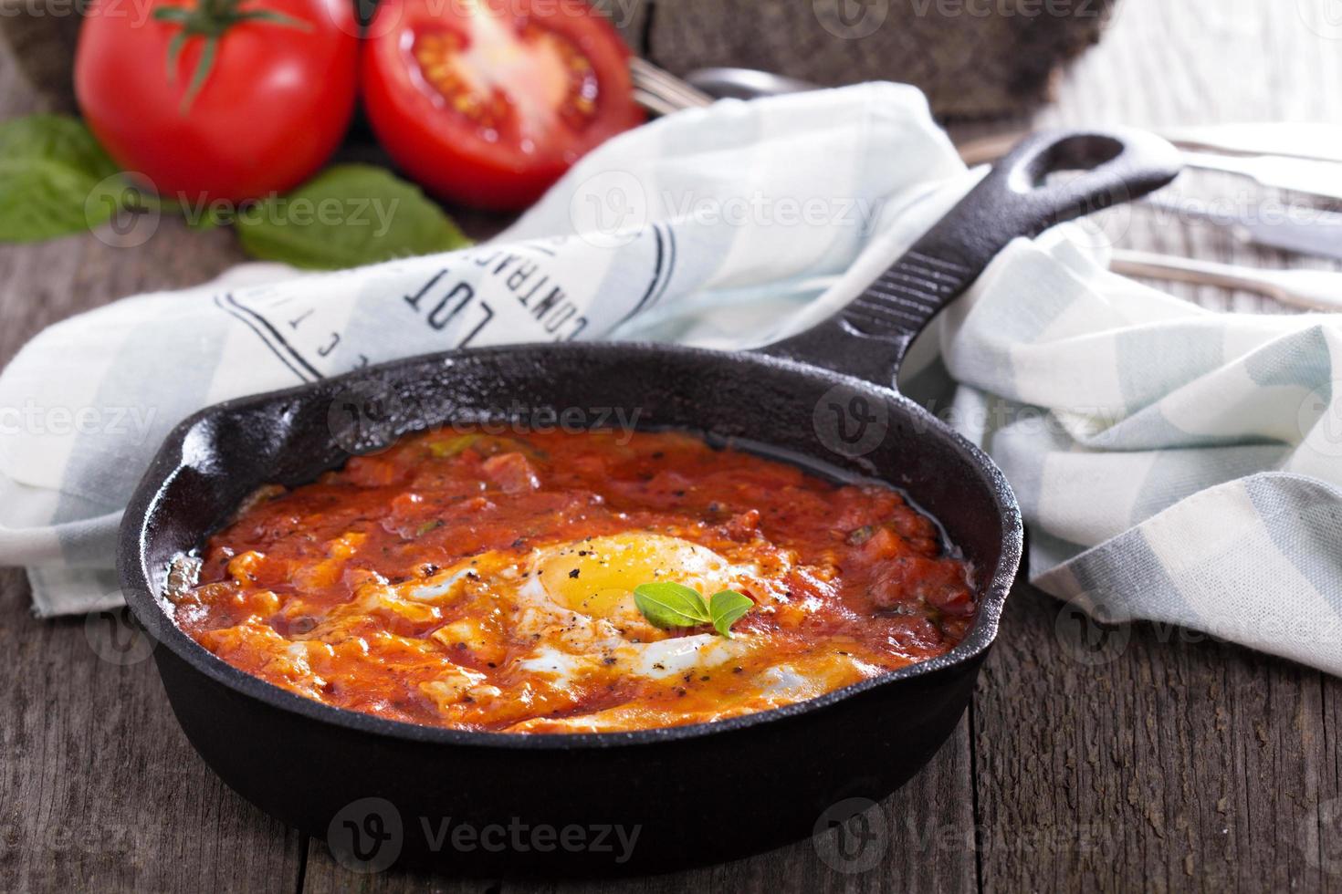 Shakshuka with tomatoes and eggs photo