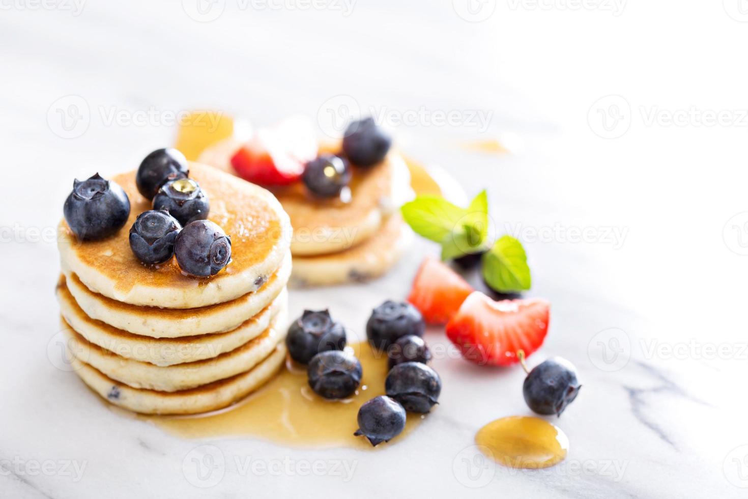 Stack of small pancakes with berries photo