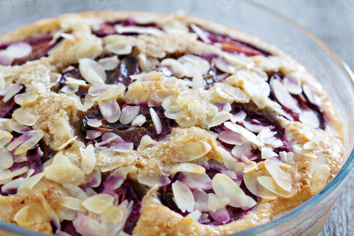 Plum and almond cake baked in a glass dish photo