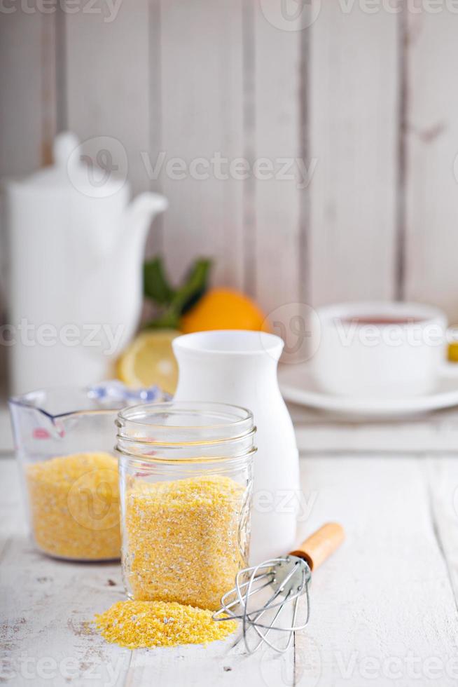 Raw cornmeal with a whisk photo