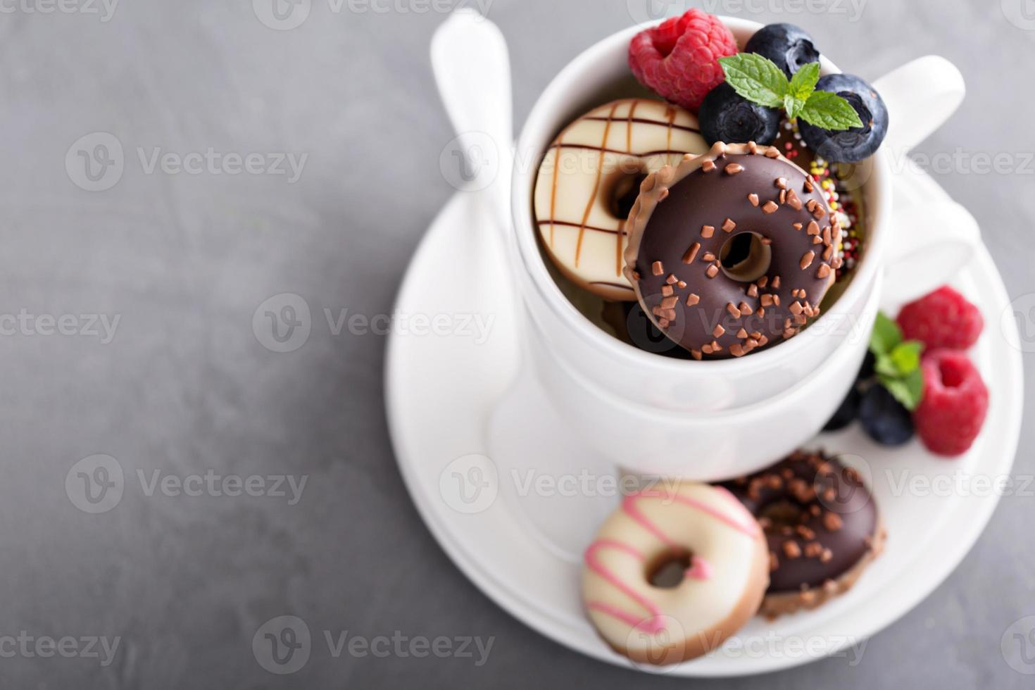 Small mini donuts in stacked coffee cups photo