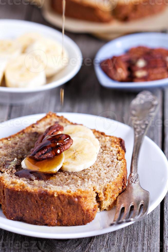 Banana bread with pecan nuts cut on the table photo